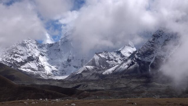 Khumbu glacier beneath Mount Everest base camp, Nepal 
dramatic clouds covering the mountains, Nepal, 2023
