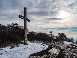 Cross standing on a snowy mountaintop