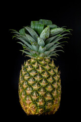 whole natural pineapple black background