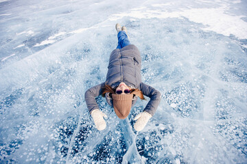 Adventure Tourist woman background ice with gas methane bubbles lake Baikal winter travel