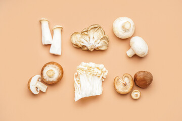 Composition with different fresh mushrooms on color background