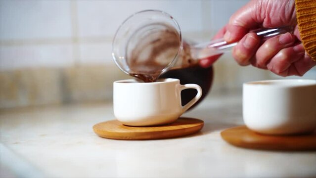 Boiling Turkish Coffee, Close Up, Modern Look. Process Of Making Coffee At Home . Woman Make Coffee In Copper Turkish Coffee Brewing Pot Over Gas Stove In Modern Kitchen Modern Cup