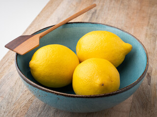 Whole organic lemons in a bowl. Close-up, concept, nobody. 
