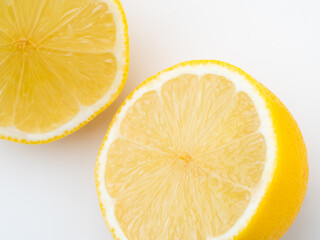 Slice of lemon on a plate. Close-up, white background. Fresh fruits.
