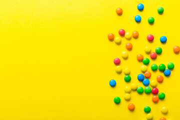 Mixed collection of colorful candy, on colored background. Flat lay, top view. frame of colorful chocolate coated candy