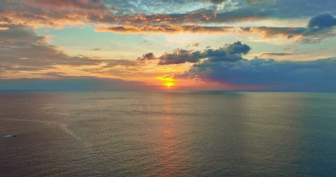 Colorful sunset or sunrise above the sea surface,Aerial view drone fly over open sea,Reflected sun beautiful light of nature on water surface,Sunset over ocean,Sea summer and travel vacation concept