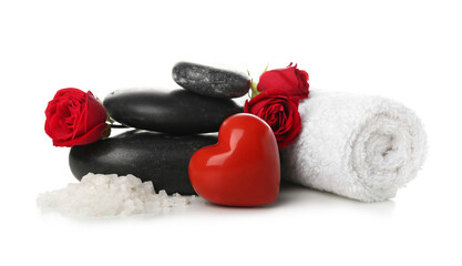 Obraz na płótnie Canvas Spa stones with sea salt, towel, heart and roses on white background. Valentine's Day celebration