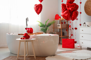 Interior of bathroom decorated for Valentine's Day with heart-shaped balloons and gifts