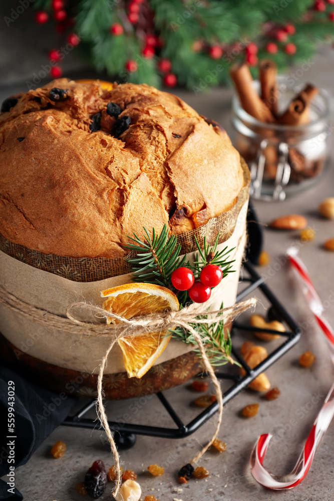 Wall mural stand with tasty panettone and christmas decor on dark table, closeup