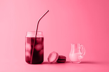 Glass of iced coffee in tall glass with cream and macaroons toned in trendy magenta color of year 2023. Food concept. Copy space. Close-up.