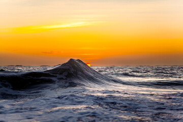 Ocean wave at sunrise