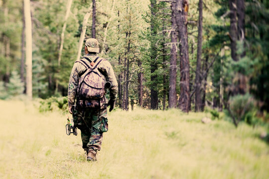 A bowhunter walks a trail in Valles Calderas, New Mexico.