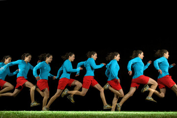 A flash sequence of a female running on green grass against a dark backdrop.
