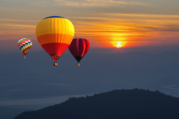 Sunrise balloons, Beautiful colorful hot air balloons flying over mountain at view point Sunset of travel place, Doi Ang Khang, Chiang mai in Thailand.