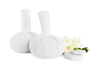 Fototapeta na wymiar Herbal massage bags, flowers and spa stones on white background