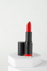 Beautiful glossy red lipstick on white background