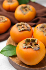 Delicious ripe juicy persimmons on table, closeup