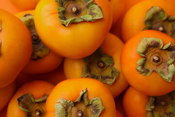 Delicious ripe juicy persimmons as background, top view