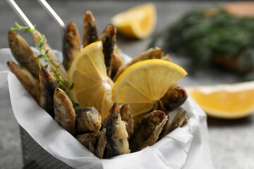 Delicious fried anchovies with slices of lemon, closeup view