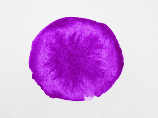 Blot of purple ink on white background, top view