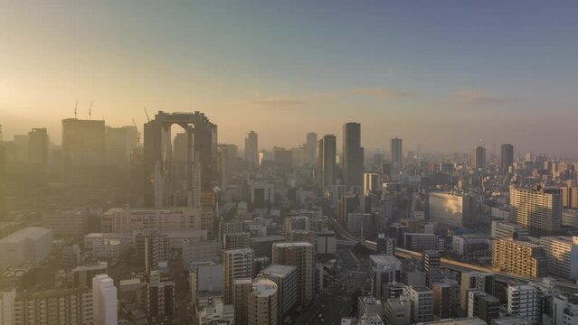 Aerial time lapse of sunrise on hazy morning in Osaka city center