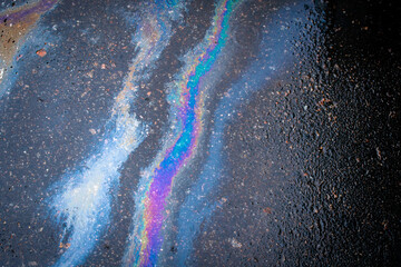 Abstract background from motor oil, gas or petrol spilled on asphalt