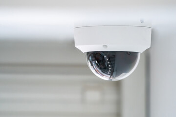 CCTV camera is installed inside the building on the ceiling and wall for monitoring and running...