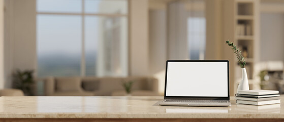 Notebook laptop mockup on marble tabletop over blurred background of minimal cozy living room