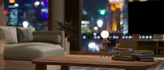 Copy space on wood coffee table in modern contemporary apartment living room at night