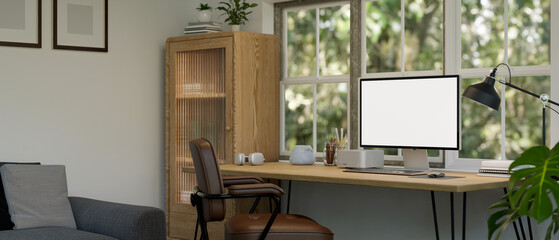 Minimal home working room with PC computer mockup on wood table against the window