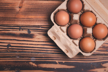 Fresh chicken eggs in cardboard boxes on wooden background
