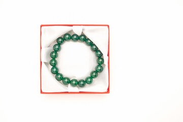 Jade bangle or bracelet in a red box on a white background