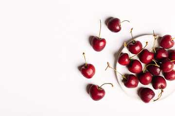 Obraz na płótnie Canvas top view cherry white background, organic natural cherries
