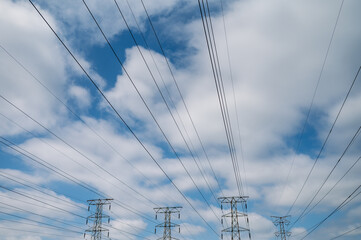 Low angle view of pylons with cabling running in line