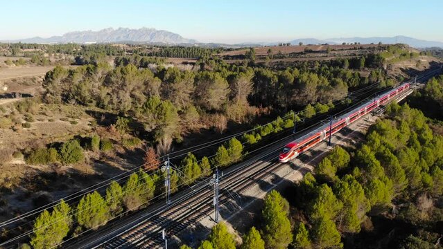 Aerial: high-speed red train in Spain, between Barcelona and Madrid in Catalonia