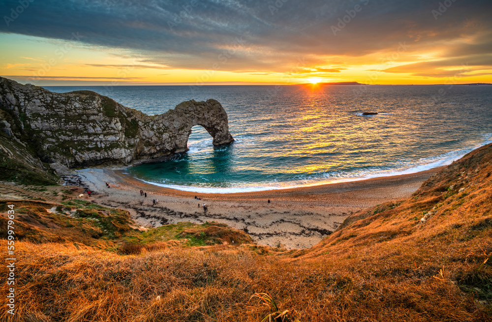 Poster durdle door at sunset in dorset, jurassic coast of england, uk