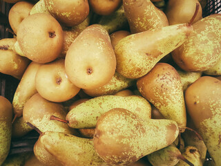 lot of pears on the supermarket counter