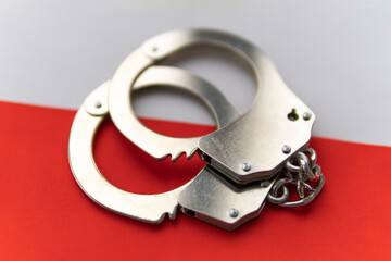 Poland flag and police handcuffs. The concept of crime and offenses in the country. concept of...