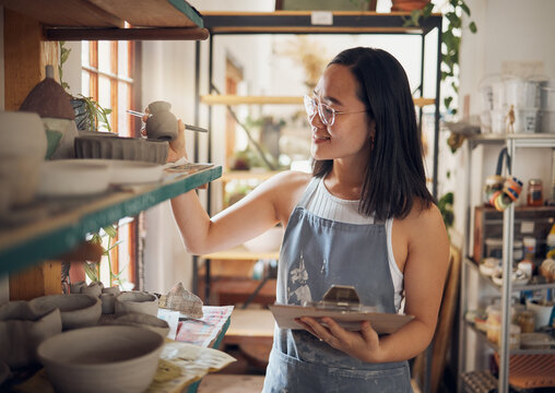 Pottery, woman or small business owner with inventory, stock and product quality, management and production results. Art startup checklist, creative worker and asian designer check design on a shelf