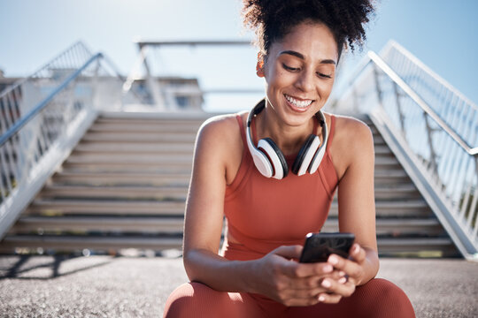 Fitness, Phone And Black Woman In City On Break On Social Media, Texting Or Web Browsing After Exercise. Sports, Cellphone And Happy Female Athlete By Stairs With 5g Mobile Smartphone For Networking.