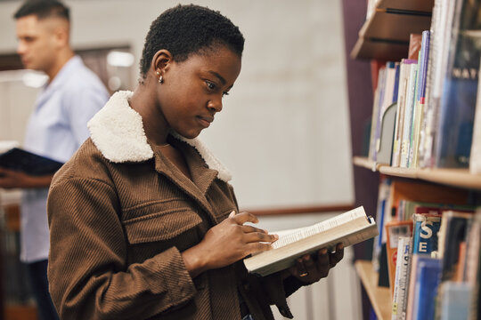 Education, book or black woman reading in library at university, college or school learning or studying. Research, scholarship or gen z African girl focused on knowledge growth or student development