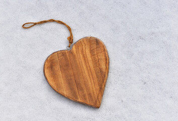 closeup on decorative wooden shape  heart on the snow