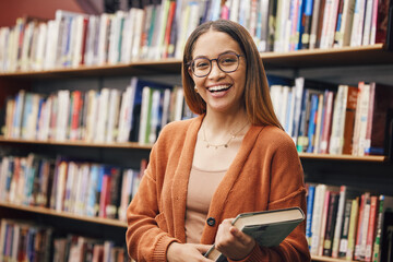 Face, student and woman in university in library ready for learning. Portrait, education and happy female from Brazil standing by bookshelf with book for studying, knowledge and literature research. - obrazy, fototapety, plakaty