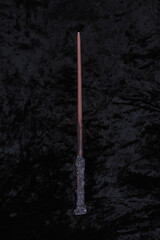 wooden magic wand on black velvet