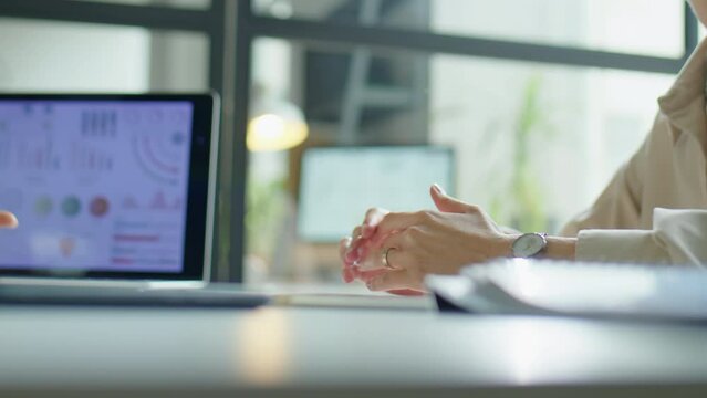 Close up shot of multiethnic businessman and businesswoman having talk and shaking hands while meeting in office