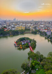 Top view aerial of Ngoc Son temple, Hoan Kiem Lake, Hanoi City with development buildings, transportation, energy power 