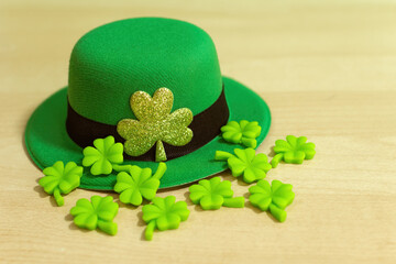 Saint Patrick's Day. Green hat of leprechaun on wooden background.