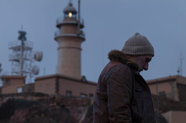 Portrait of adult man in leather jacket with lighthouse. Almeria, Spain