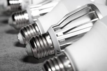 E27 base of the LED lamps with radiator on grey background.