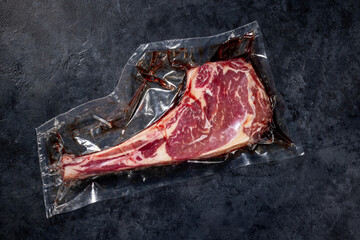 Raw Tomahawk beef steak and spices